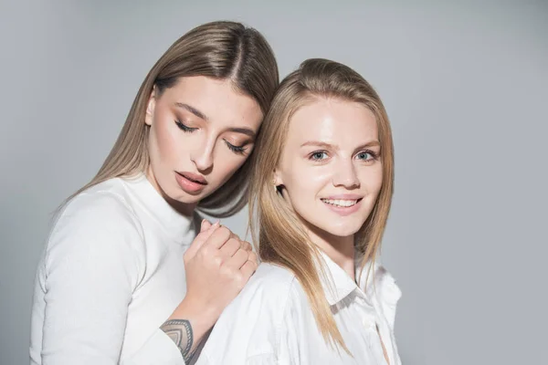 Portrait of two cheerful young women. Two beautiful young women with perfect skin in the studio. Lesbians lgbt couple. — Photo
