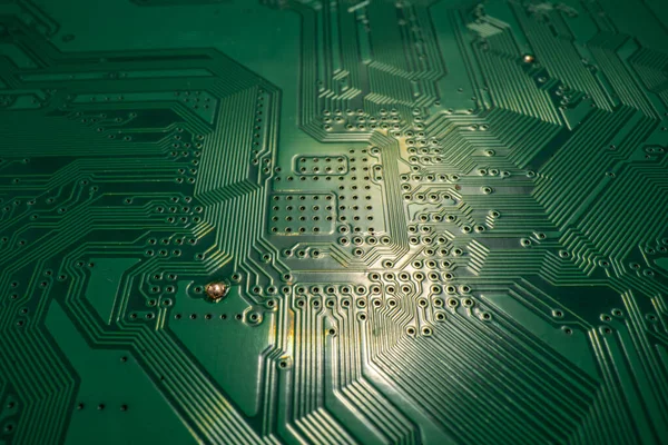 Circuit board. Technological electronic plate with roads and other components, selective focus. Technology background, electronics texture. Stock Picture