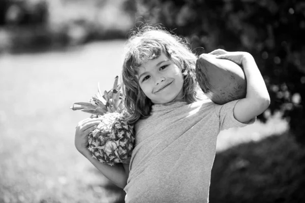 열 대 정원에서 파인애플 과 코코넛을 키우는 귀여운 아이야. 아이들을 위한 신선 한 열 대 과일이에요. 신선 한 열 대 유기농 과일로 건강 한 생활. — 스톡 사진