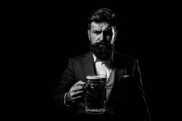 Serious fashion man in suit with cup glass of beer isoalted on black, copy space. — Stock Photo, Image