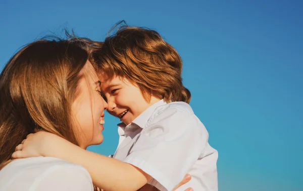 Mutterschaft. Kind Sohn umarmt Mutter. Mutter und Junge lächeln und umarmen sich. Familienurlaub und Zweisamkeit. — Stockfoto