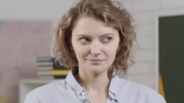 Portrait of a female student in university. Thinking female face. Smiling girl student or woman teacher portrait. Learning and education concept. — Stockvideo