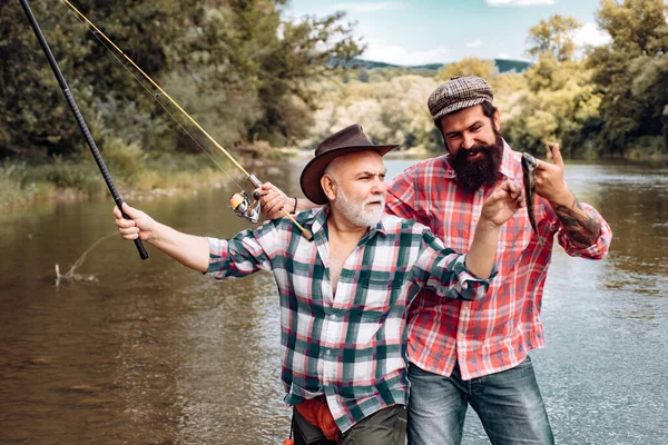 Fisherman men friends and trophy trout. Father and son fishing. Generations men fishing in river. — Stock Photo, Image
