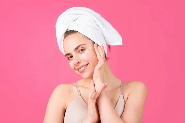 Beautiful young woman with clean skin. Girl beauty face care. Facial treatment. Spa skin care, smiling woman wearing hair towel after beauty treatment. Beautiful perfect skin, isolated background. —  Fotos de Stock