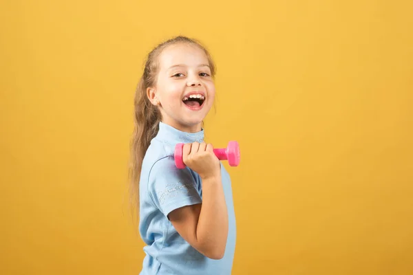 Girl workout in park. Kids sport. Child exercising with dumbbells. Sporty and fitness child with dumbbell outdoor. Kids sport. Kids active healthy lifestyle. Sport portrait kids. — Stockfoto