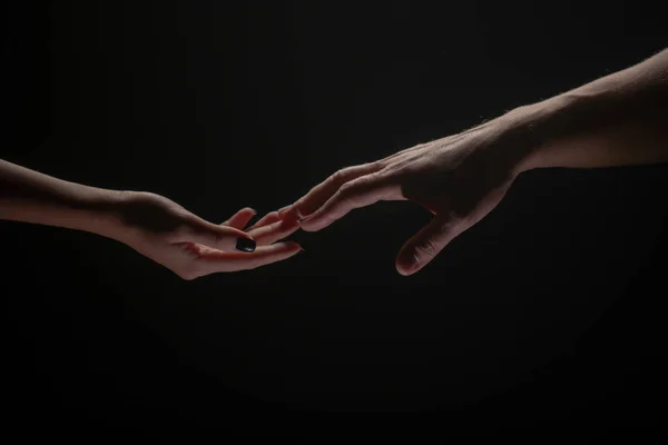 Hands at the time of rescue. Friendly handshake, friends greeting, teamwork, friendship. Rescue, helping gesture or hands. Romantic touch with fingers, love. — Stockfoto