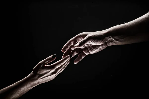 Two hands. Helping hand to a friend. Rescue or helping gesture of hands. Concept of salvation. Hands of two people at the time of rescue, help. Isolated on black background. — 스톡 사진