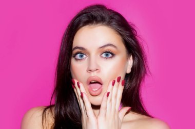 Surprised young woman. Shouting mouth, screaming face. Unbelievable. Portrait of excited woman spreading hands.