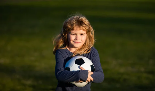 Soccer boy, child play football. Kid holding soccer ball, closeup kids portrait. — Zdjęcie stockowe
