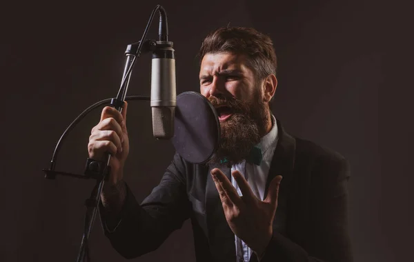 Music festival. Singer performing a song with a microphone while recording in a music studio. — Stock Photo, Image