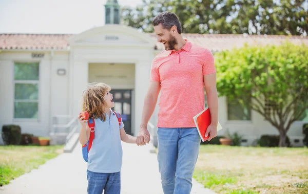 Father and son go to school, education and learning. School boy going to school with father. — Stock Photo, Image