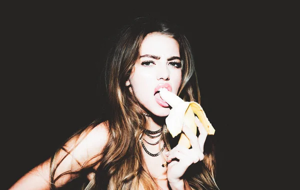Portrait of seductive young woman eating banana. Tropical fruits. Summer concept. Healthy eating. Sexy sweet dreams. — Stock Photo, Image
