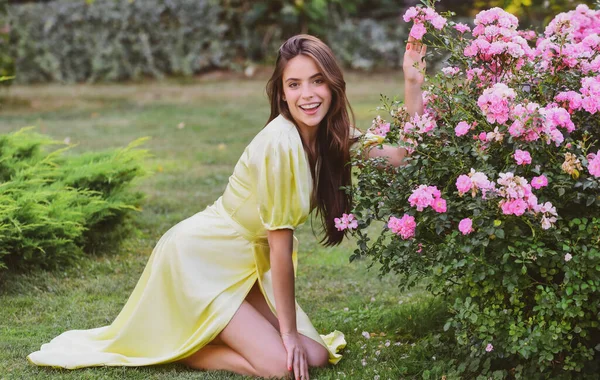 Mujer de primavera en jardín de rosas al aire libre. Belleza natural. Mujer disfrutar de la recreación de verano. Primavera. — Foto de Stock