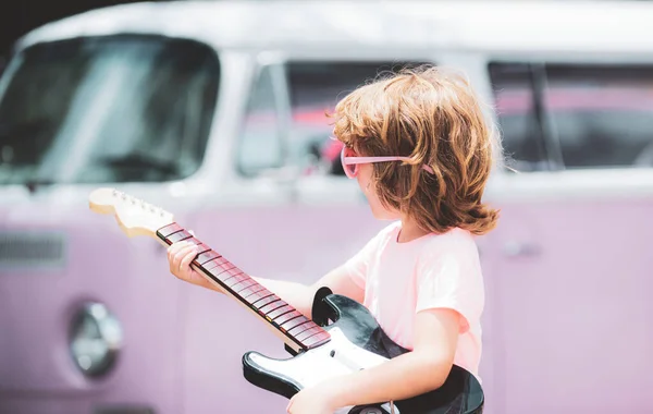 Rock and roll child. Portrait of cute boy playing a guitar. Music concept. Kids music school. — Stock Photo, Image