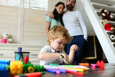 Happy family portrait having fun together. Father mother and child son drawing. Kid learning painting, little artist painting, drawing. Children day.
