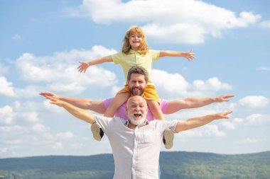 Grandfather with son and grandson having fun, raising hands or open arms flying on sky. Start, creativity startup concept.