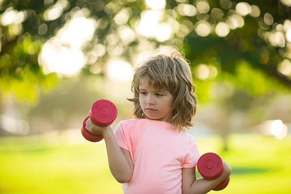 Fitness dumbbells kid exercise workout outdoor. Boy sporty child with dumbbells. — 스톡 사진