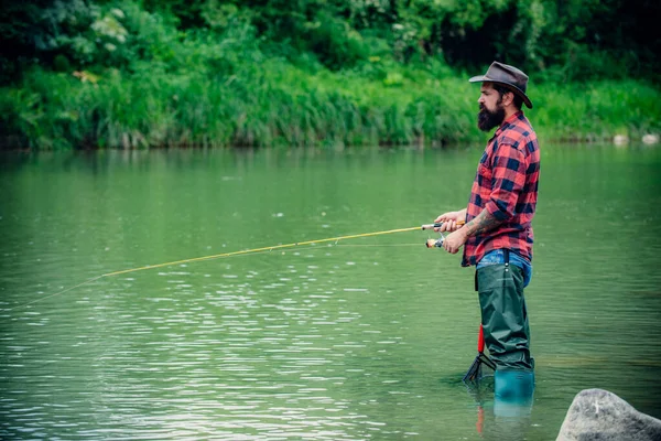 Fisherman caught a fish. Man angler fishing on river. — Stockfoto