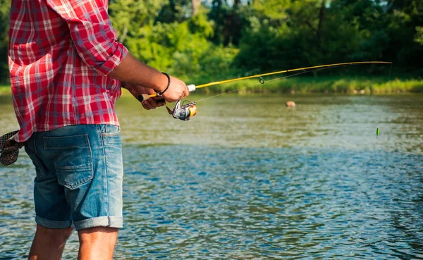 Fishing hobby and summer weekend. Bearded men fisher with fishing rod and net. — ストック写真