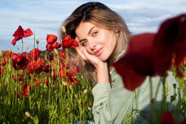 Beautiful young woman in poppy field. Woman on flowering poppy field. Summer holidays on nature. Girl on poppies meadow with poppys flowers. — Stock Photo, Image