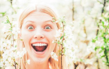 Güzel kadın portresi. Yakın çekim. Papatya çiçeği, çayırda çiçek açan papatya çiçekleri. Beyaz çiçekli bahar kenar arkaplanı.