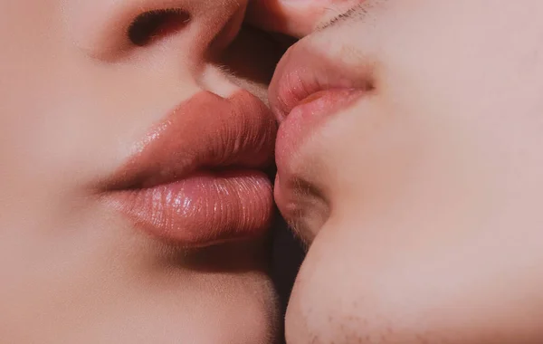 Sensual kiss close up. Close-up two lips kissing sensual intimate, young man woman kiss.