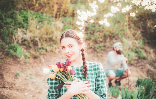 Веселая молодая женщина, заливающая цветы. Садоводческая концепция . — стоковое фото
