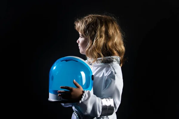 Portrait of funny kid with astronaut helmet. Child boy playing astronaut, spaceman