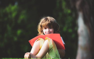 Mesafeli çocuklar kurşun kalemle kitap yazmayı öğreniyorlar. Çocuk yazmayı öğreniyor, okul öncesi eğitim konsepti.