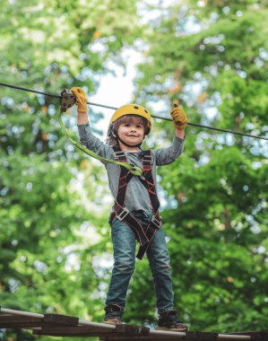 Erken çocukluk gelişimi. Eco Resort Faaliyetleri. Çocuk bahçesi. Çocuk çocuk macera ve seyahat. Küçük çocuk kask ve güvenlik ekipmanları ile macera aktivite parkı tırmanma