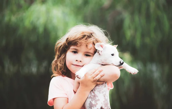 Hug friends. Happy child and dog hugs her with tenderness smiling