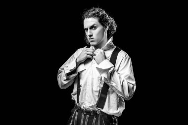 Man with serious face and brutal style isolated on black background. Copy space. Young handsome brunet. Barbershop advertising. Urban lifestyle concept