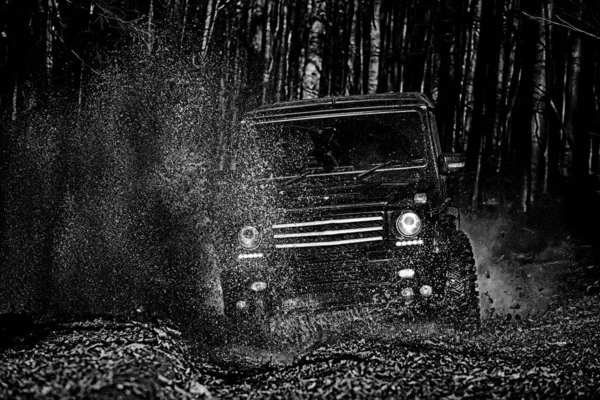 Mud and water splash in off the road racing. Off-road travel on mountain road. Tracks on a muddy field. Road adventure. Adventure travel