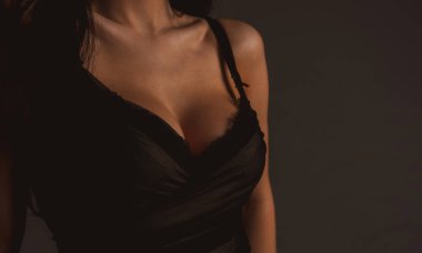 Women with large breasts. Sexy breas, boobs in bra, sensual tits. Beautiful slim female body. Lingerie model. Closeup of sexy female boob in black bra