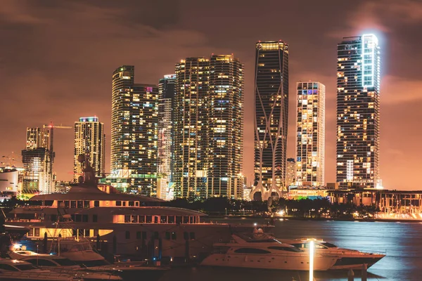 Miami south beach street view with water reflections at night. Miami night downtown, city Florida