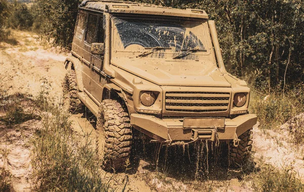 Mud and water splash in off the road racing. Tracks on a muddy field. Off-road travel on mountain road. 4x4 travel trekking