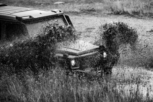 Off-road vehicle stuck on impenetrable road after rain in the countryside. Travel and racing concept for 4x4 drive off road vehicle