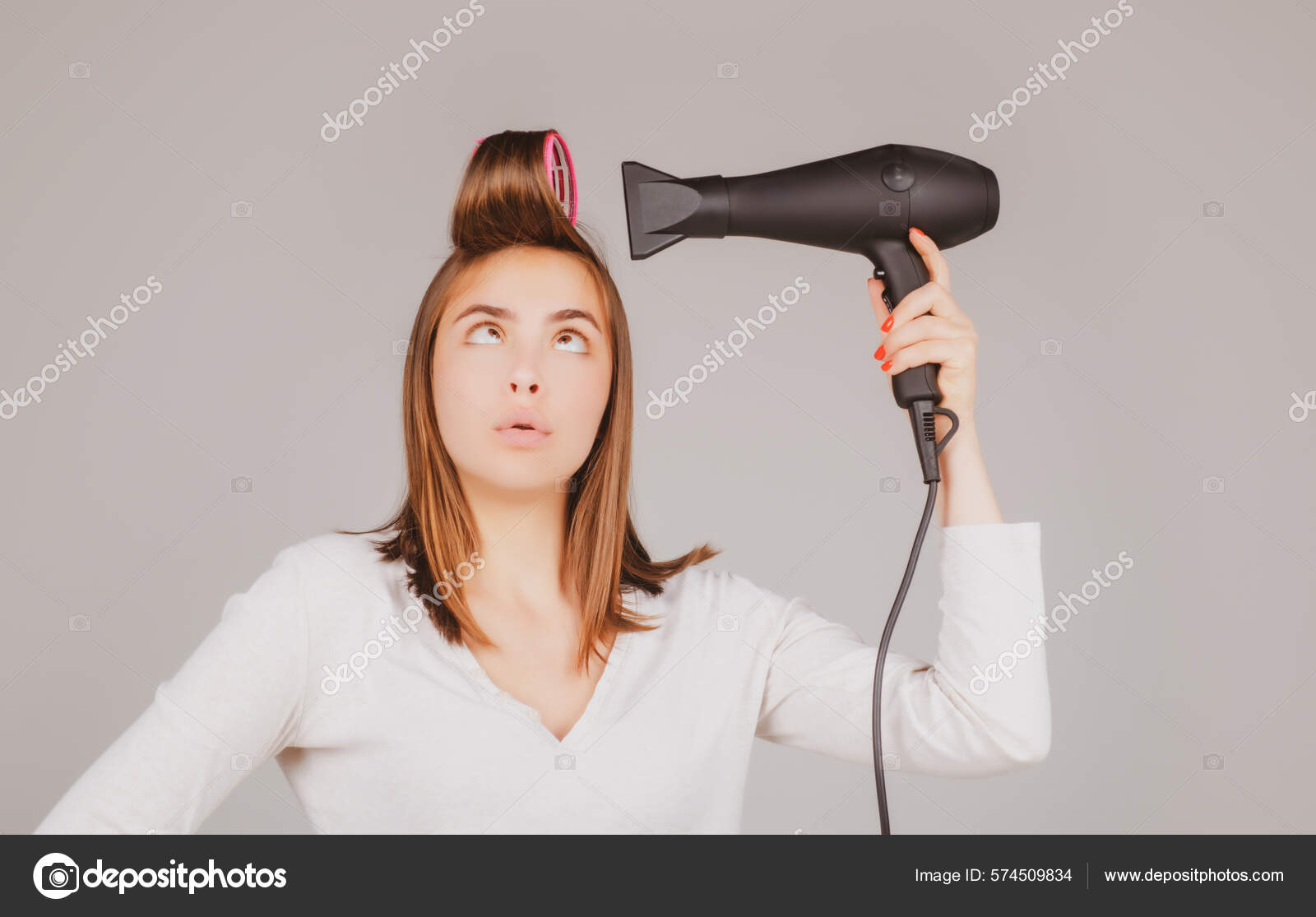 Mão feminina segurando secador de cabelo, isolado