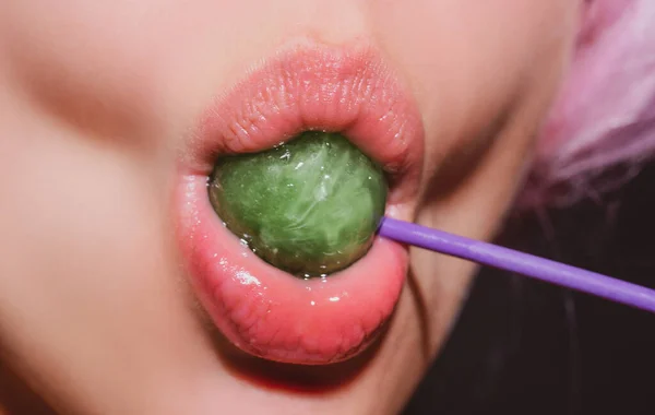 Sucking lips. Lips with candy, sexy sweet dreams. Female mouth licks chupa chups, sucks lollipop