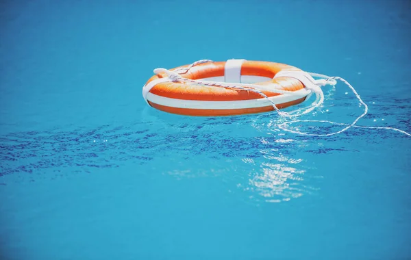 Help and drowning concept. Life saver ring floating in the water