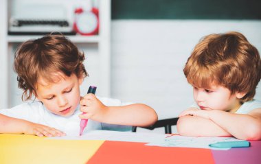Back to school. Children at the blackboard. Kids with a book. Cute little boys pupils with cute study
