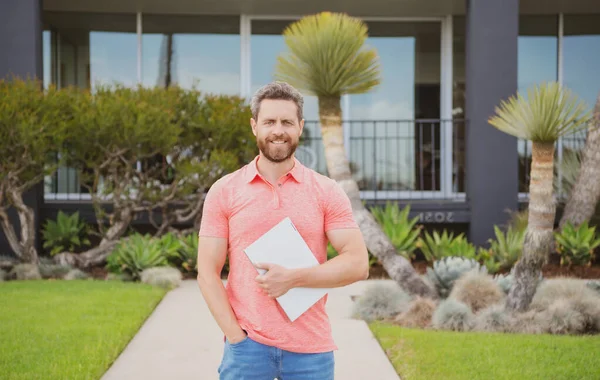 Businessman outside near house, rent new home