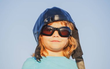 Çocuklar rüya görür. Pilot kasklı, gözlüklü, komik portresi olan beyaz bir çocuk. Çocuk yüzü