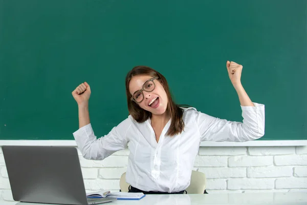 Portrait of funny excited young woman student in university or high school college