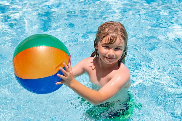 Child splashing in swimming pool. Active healthy lifestyle, swim water sport activity on summer vacation with child. Child water toys
