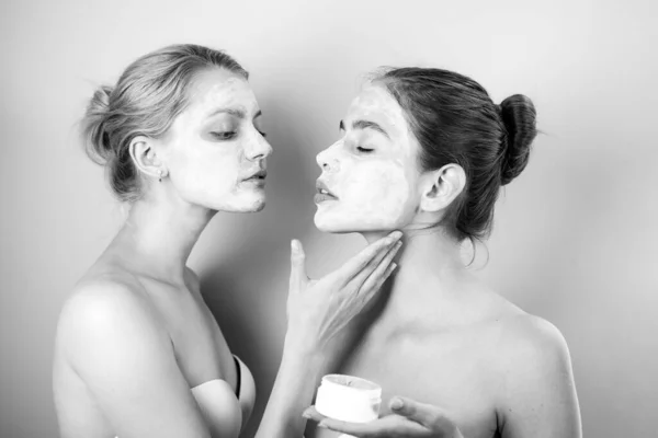 Spa and wellness. Girls friends sisters making clay facial mask. Anti age care. Stay beautiful. Skin care for all ages. Women having fun skin mask. Pure beauty. Beauty product. Applying clay mask.