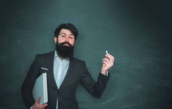 Academic success is much more about hard work than inborn talent. High school concept copy space. World teachers day. Bearded professor at school lesson at desks in classroom