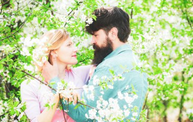 Romantic couple in love feeling happiness. Happy couple in love outdoors. Happy couple smiling in a spring park on a sunny day