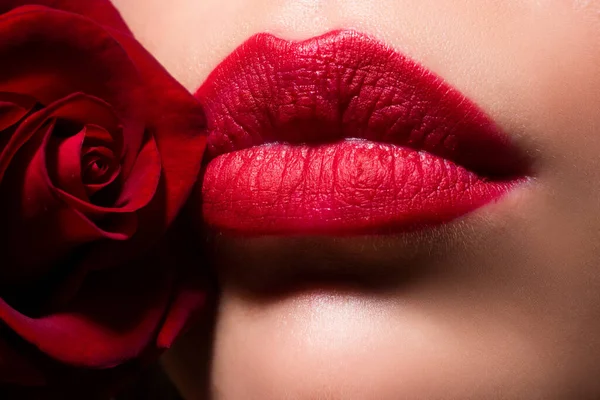 Womans lips with red lipstick and kiss gesture Beautiful woman lips with rose