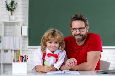 First day at school. Cute little boy studying lesson in class. Teacher and little student portrait, teachers day clipart